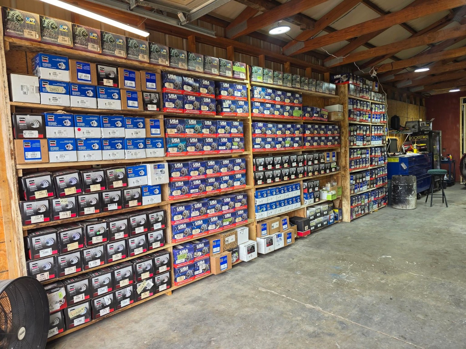 Shelves of starters and alternators inside the StarterWorx shop